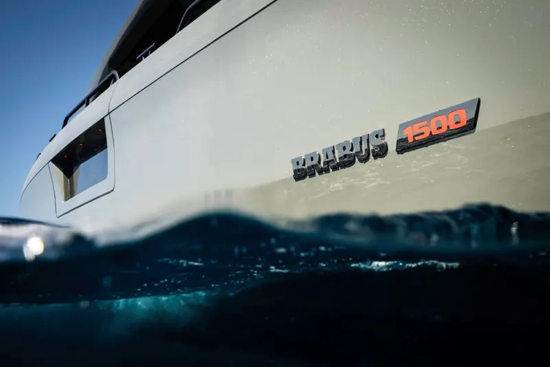 The waterline badge on a Shadow 1500, half submerged, showing the orange-on-black model numerals against the painted hull.