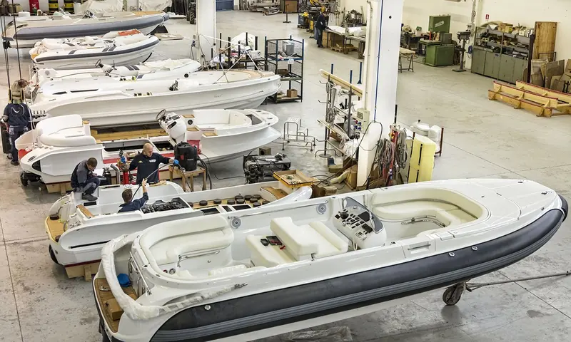 Jet tenders at different stages of build stand in rows on the shop floor, hulls, tubes and consoles going together.