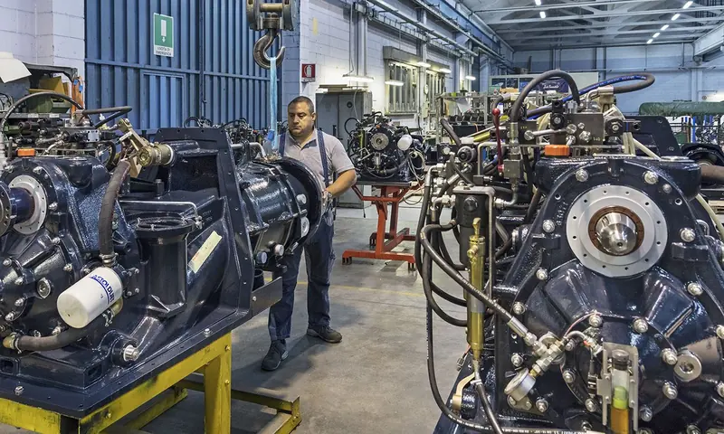 Waterjet units on trolleys on the assembly floor, hoses and hydraulic fittings already made up.