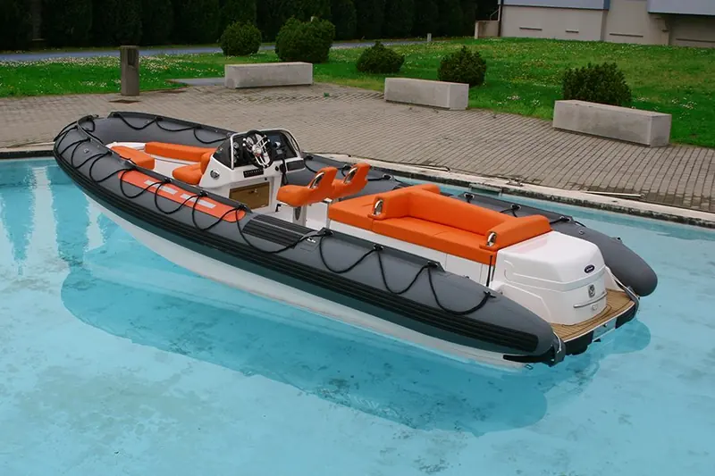 A tender with orange upholstery and a grab line round the tube floats in the test pool at the works.