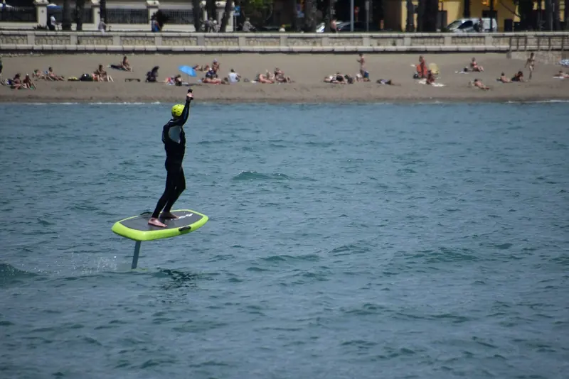 Riding off La Malagueta in Malaga, high on the mast. Ride height is trimmed by weight over the front foot and by the throttle in the hand controller.