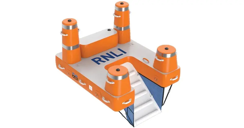 An RNLI-branded FunAir platform with four boarding towers and a mesh-sided slide, built to order rather than off the shelf.