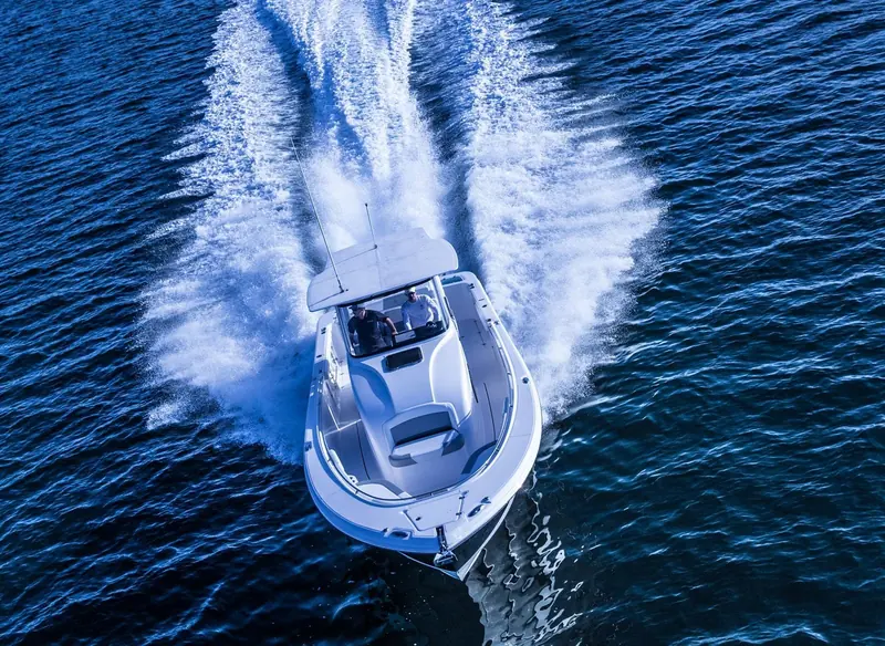 A center-console fishing boat running hard offshore, the everyday hull a Garmin chartplotter, radar and autopilot package is built to be read and trusted on at speed.