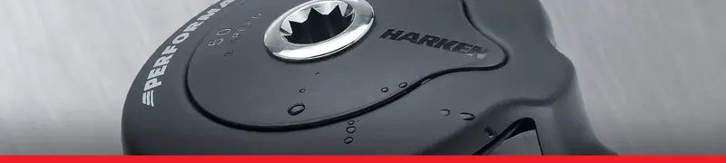 A Harken Performa 50 two-speed self-tailing winch, wet with spray. The Performa line sits between the entry-level Radial and the top Air winches used in grand prix racing.