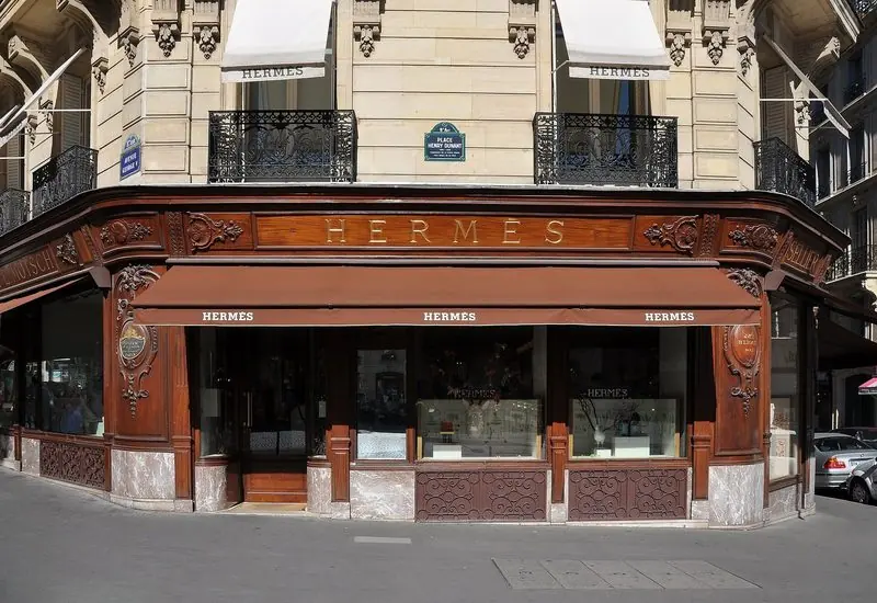 Carved wood and brown awnings front the Hermes store on Avenue George V in Paris.