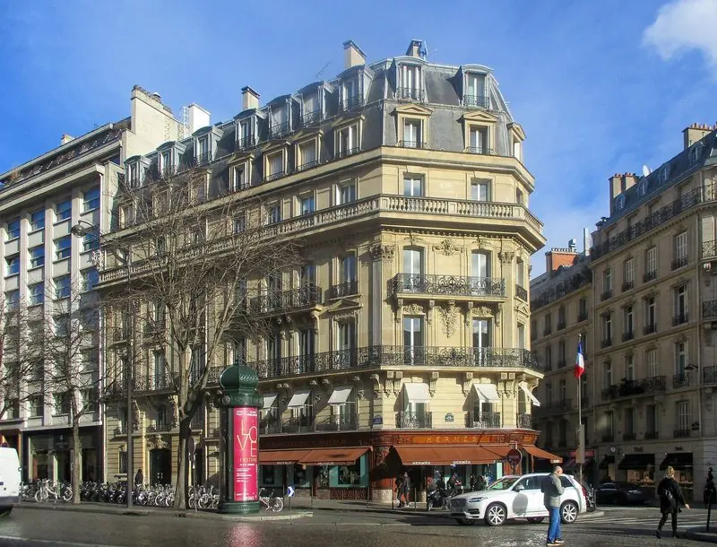 Winter sun falls on the Haussmann corner building that houses the Hermes shop on Avenue George V.