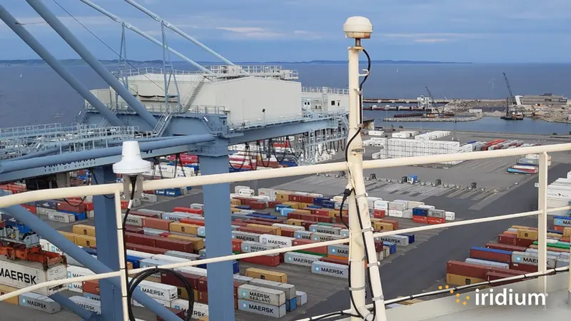 A compact Iridium-Connected antenna mounted on a container ship's railing; GMDSS terminals like the LT-3100S use this class of low-profile antenna for SOLAS safety compliance.