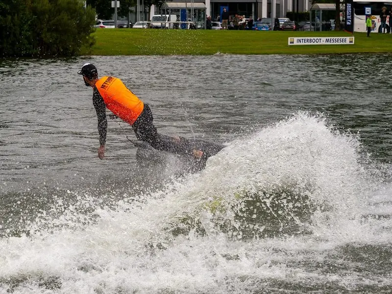 A rider in a JetSurf bib throws up spray on the Messesee at Interboot in Friedrichshafen.