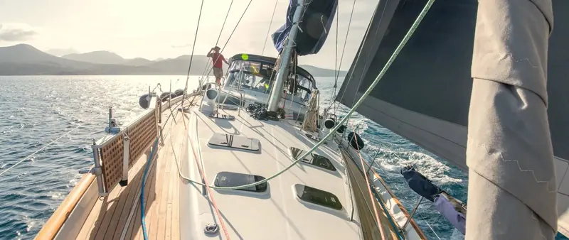 The foredeck of a sailing yacht underway, fitted with Lewmar hatches set flush into the coachroof.