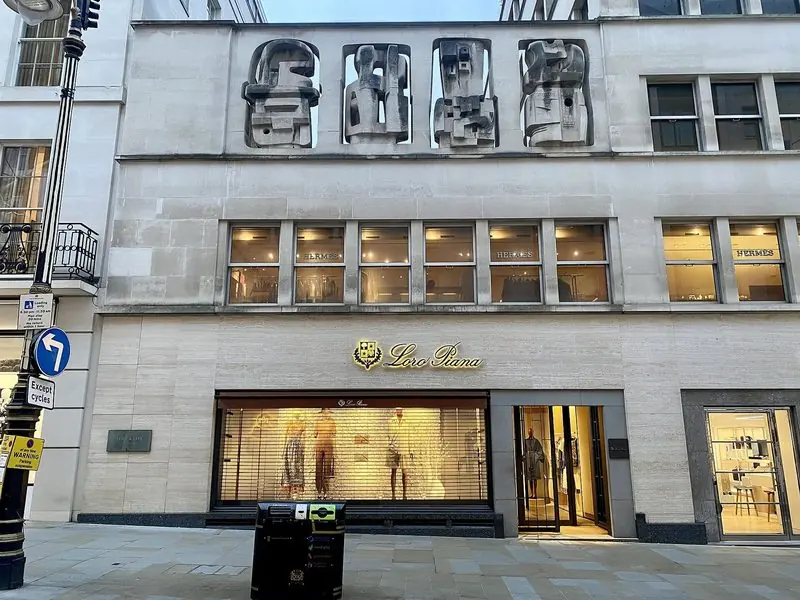 Loro Piana's London flagship on New Bond Street, below the carved stone figures of Henry Moore's Time-Life Screen.