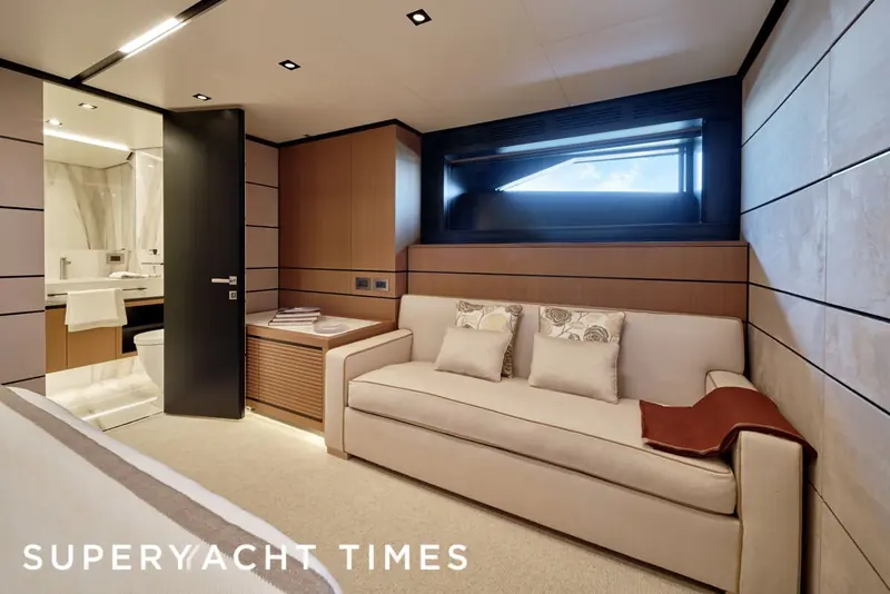 A second stateroom, the headboard and soft furnishings carrying the same cashmere and linen blends through every cabin.