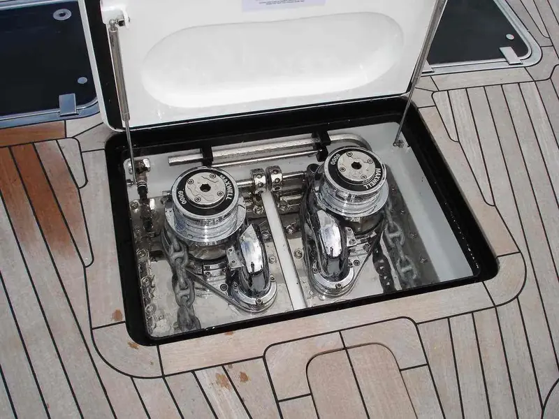 Twin Maxwell VWCLP6000 windlasses in an open deck locker aboard the Fitzroy Yachts sailing yacht Zulu, teak decking around the hatch.