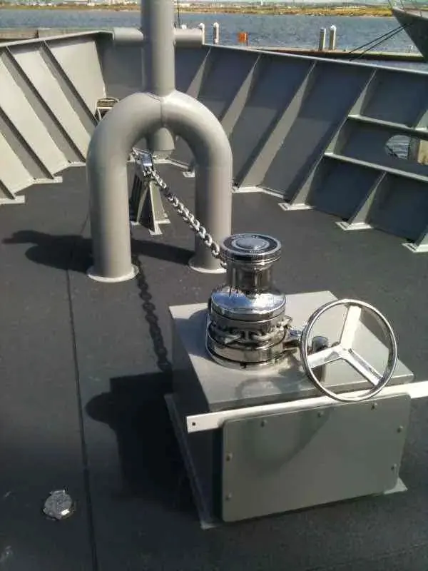A single Maxwell VWC6000 windlass mounted on the non-slip foredeck of a 114-foot US Navy support vessel.