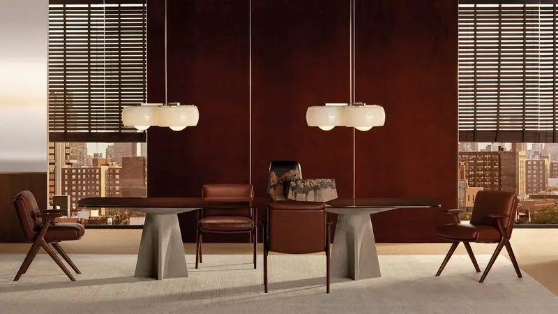Slim dark chairs surround a long dining table in a room panelled in oxblood lacquer.