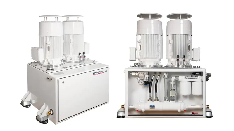 A Naiad Dynamics twin-motor hydraulic power pack, branded on the cabinet, shown open and closed: the two AC motors that drive the pumps, the filter housings and the seawater heat exchanger along the base.