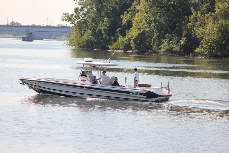 The same tender from ahead of the beam, hardtop over the centre console and the helm seat set well forward.