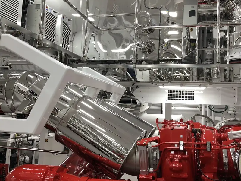 A Quantum zero-speed fin actuator installed in a yacht's engine room, mounted beside the main engines and gearboxes.
