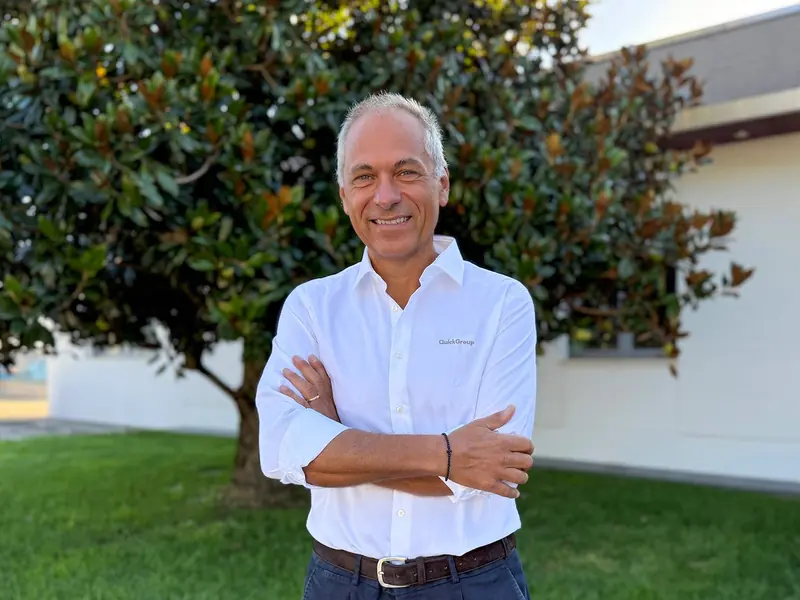 A Quick Group executive in a company-branded shirt, photographed outdoors at the Piangipane headquarters