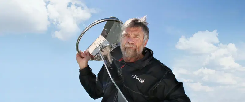 Rocna designer Peter Smith with a stainless steel Rocna Original, the roll bar visible over his shoulder