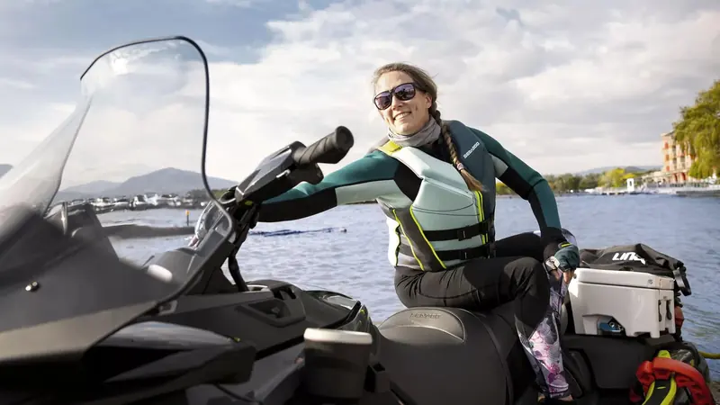 A rider reaching for the handlebar of an Explorer Pro, showing the reach and seat height that decide who can control the craft confidently.