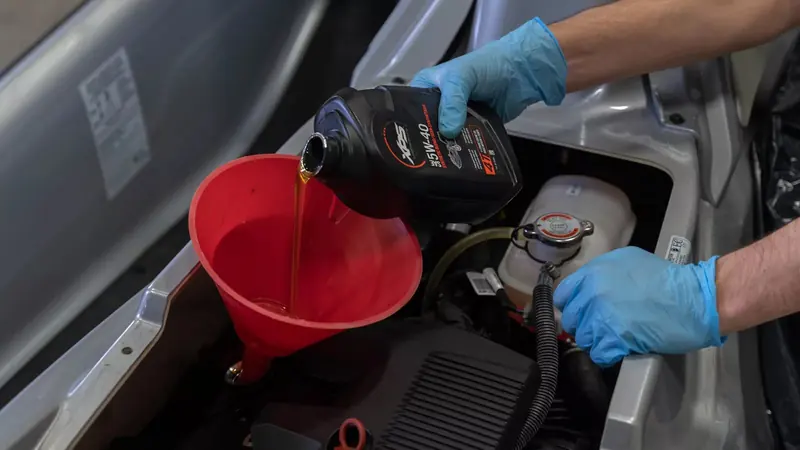 A season-end oil change on a Rotax engine, the annual service point most owners hand to a dealer rather than doing themselves.