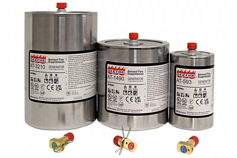 Three stainless steel Sea-Fire AT-series aerosol generator canisters, labelled AT-3210, AT-1490 and AT-593, stand beside their red-capped activation heads on a white surface.