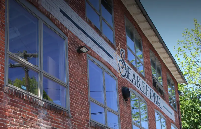 Seakeeper's own brick factory building in Maryland, the company name painted across the upper storey between the original sash windows.