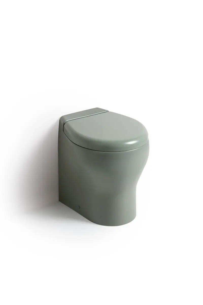 The same Tecma toilet body in a matte sage-grey finish, one of the colour options offered alongside white for matching a yacht's interior joinery