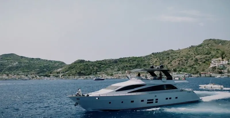 An IPS-powered flybridge yacht cruising off a Mediterranean coastline, well within the mid-size range where the system is now the default choice.