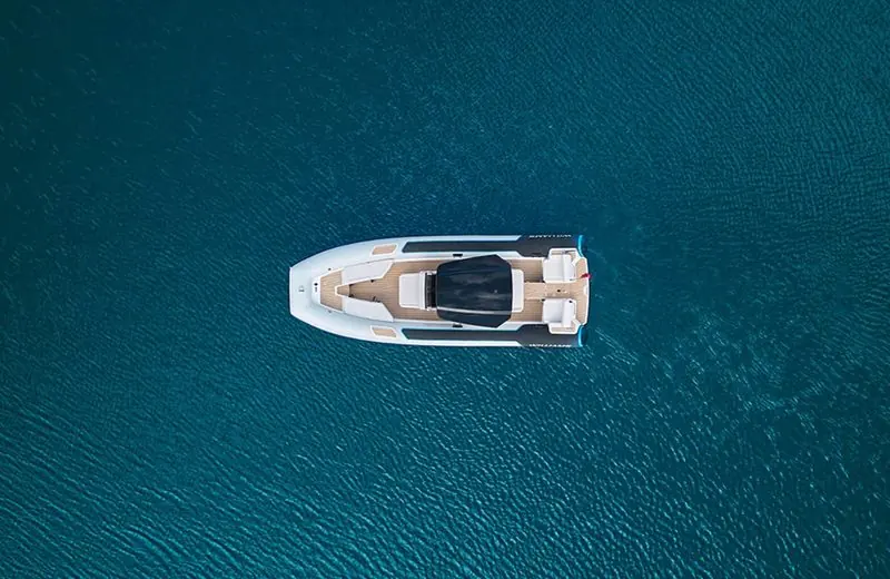 Seen from directly overhead, a Williams tender sits alone on deep blue water.