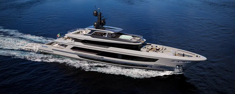The Baglietto T52 cruising broadside at speed, her low flush deckhouse and dark hull typical of the yard's displacement range