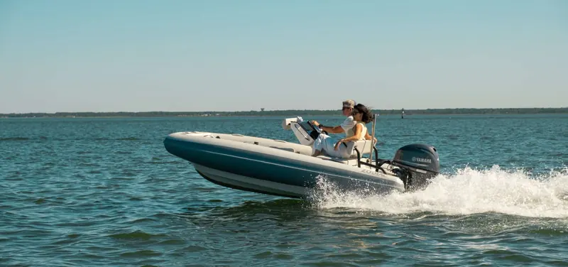 A Zodiac tender on plane close to shore, the inflatable tube and rigid hull combination the brand has built since the 1930s.