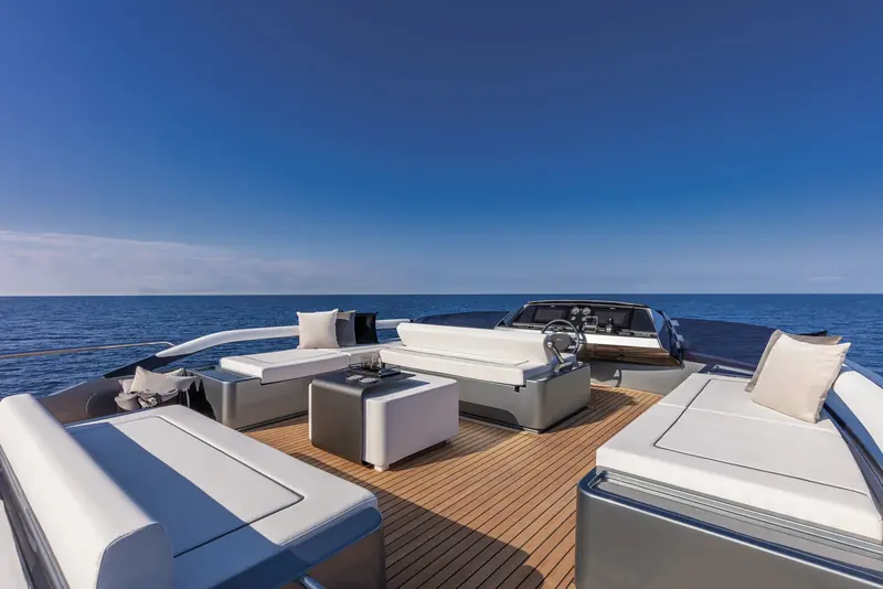 Aft cockpit seating faces forward under an open sky, upholstered in Riva's usual cream and dark leather.