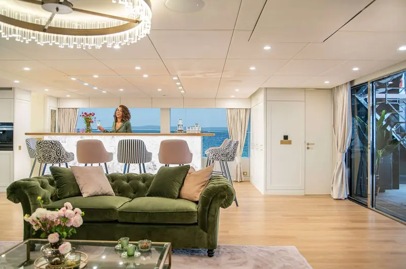 Guests at the saloon bar, with the full-beam glazing behind giving an uninterrupted view out to the water on both hulls.