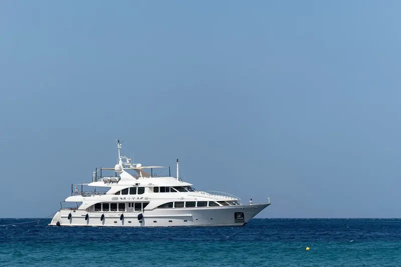 A classic Benetti motor yacht lying at anchor off Agios Romanos on Tinos, Greece