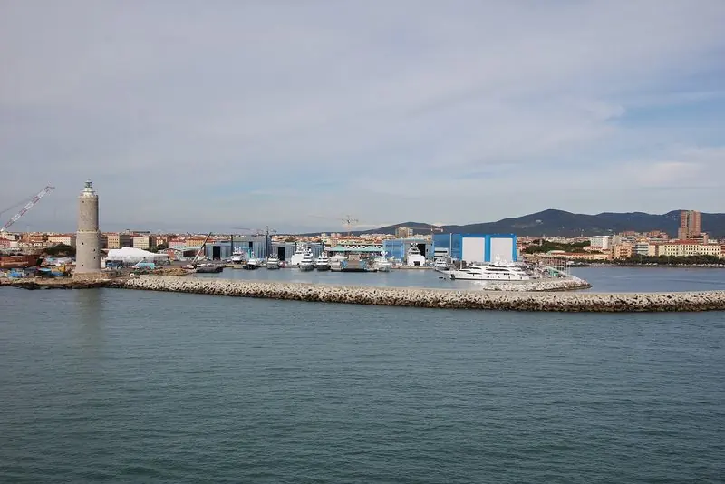 Superyacht sheds and moored yachts behind the breakwater in the port of Livorno