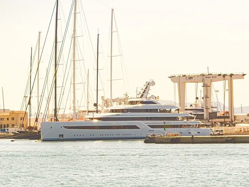 Sunrise light over Port de Palma, where a low profile Feadship lies against the yard quay.