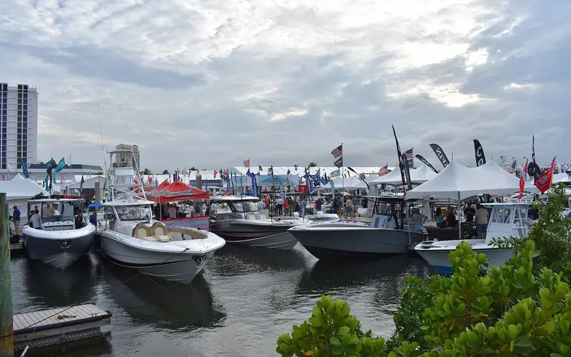 Center console boats and exhibitor tents lining the docks at the Fort Lauderdale International Boat Show