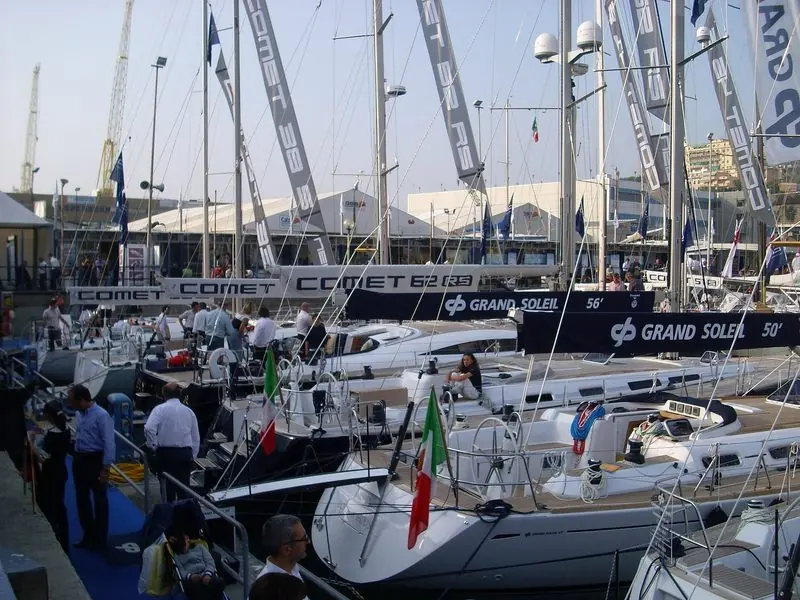Visitors work their way along a pontoon of cruising yachts at the Genoa show.