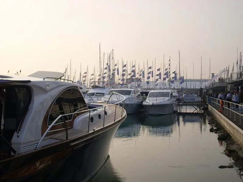 Evening haze settles over the show basin and a long line of brand flags.