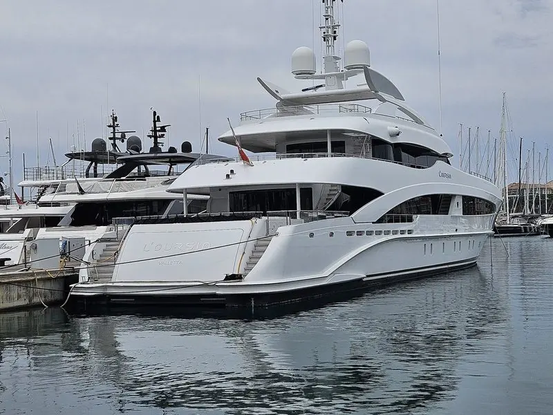Stern to at Antibes, a Heesen fills her berth beside a row of masts.