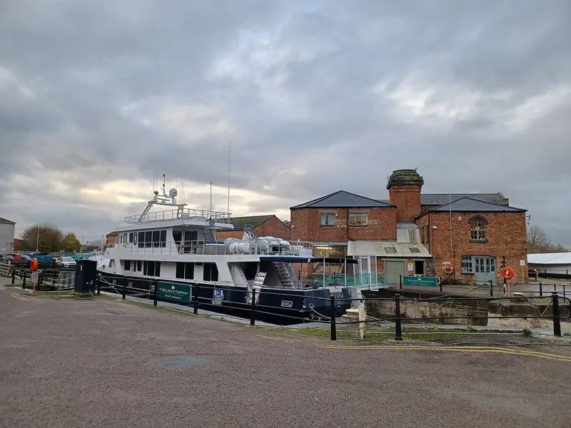 A motor vessel laid up beside a traditional shipwright yard at Gloucester Docks, England