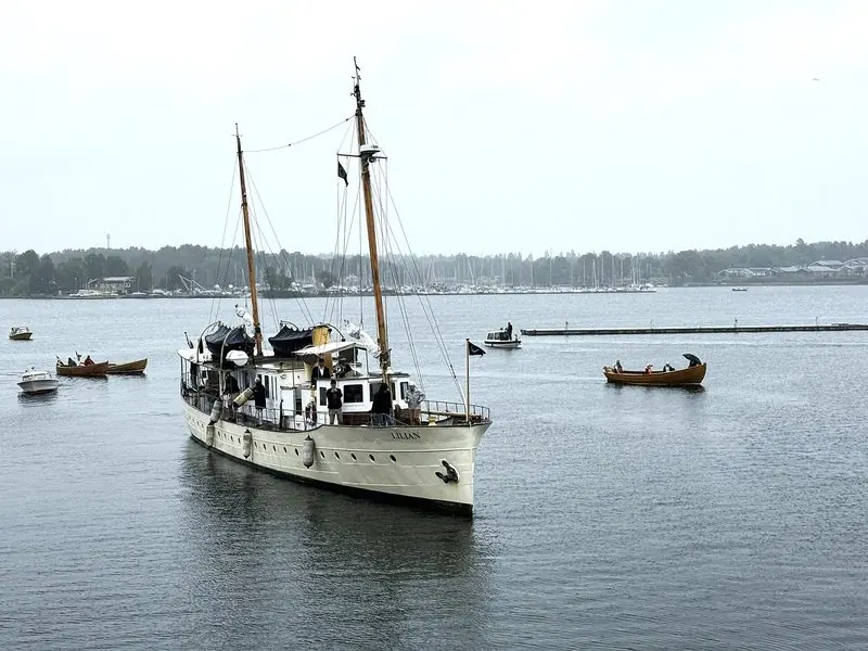 The motor yacht Lilian, built and launched in Stockholm in 1916, arriving in Vastervik escorted by small boats