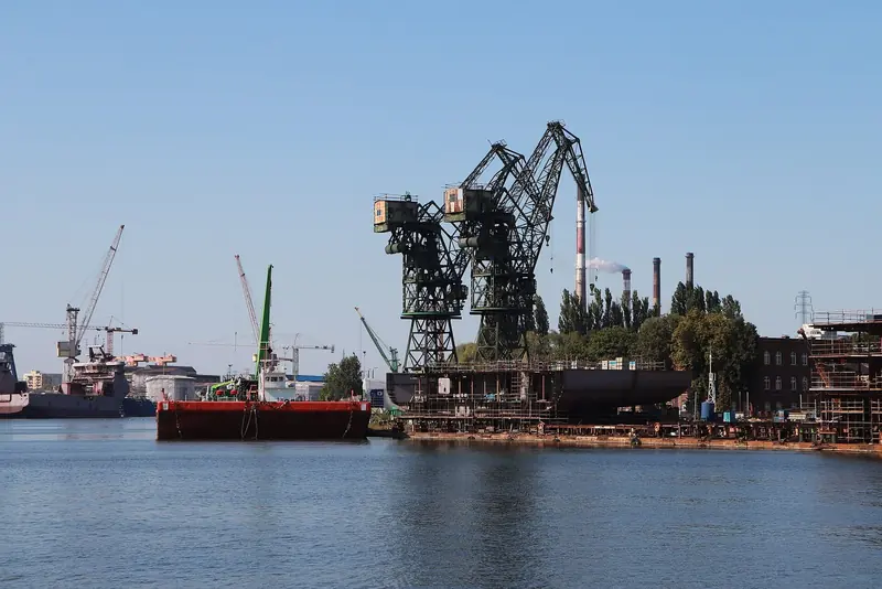 A steel hull under construction beneath the gantry cranes on the Motlawa river at Gdansk.