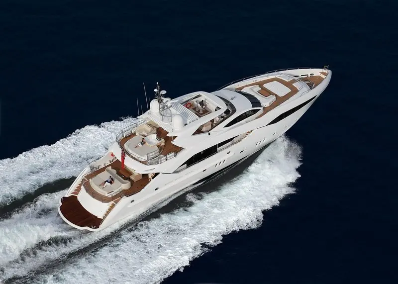 A Sunseeker runs at speed across deep blue water, seen from above.