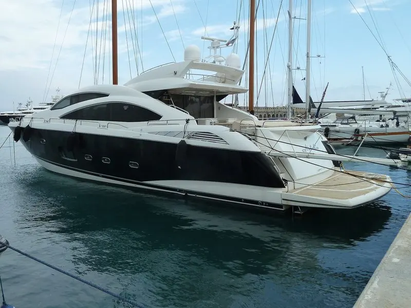 Stern to among the masts, a flybridge Sunseeker shows her teak bathing platform.